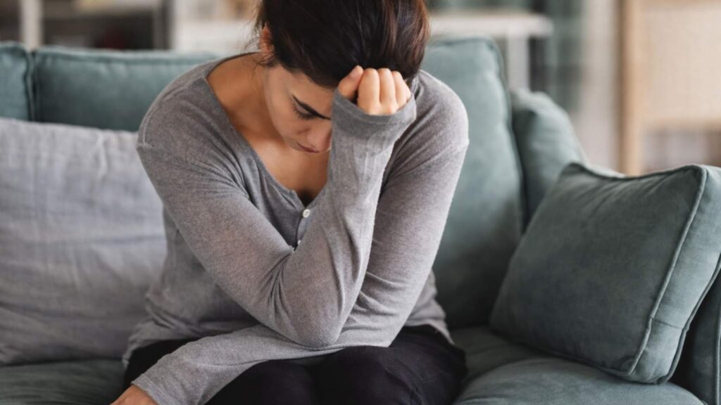 Common signs of depression in women: Woman experiencing physical symptoms of depression including chronic fatigue