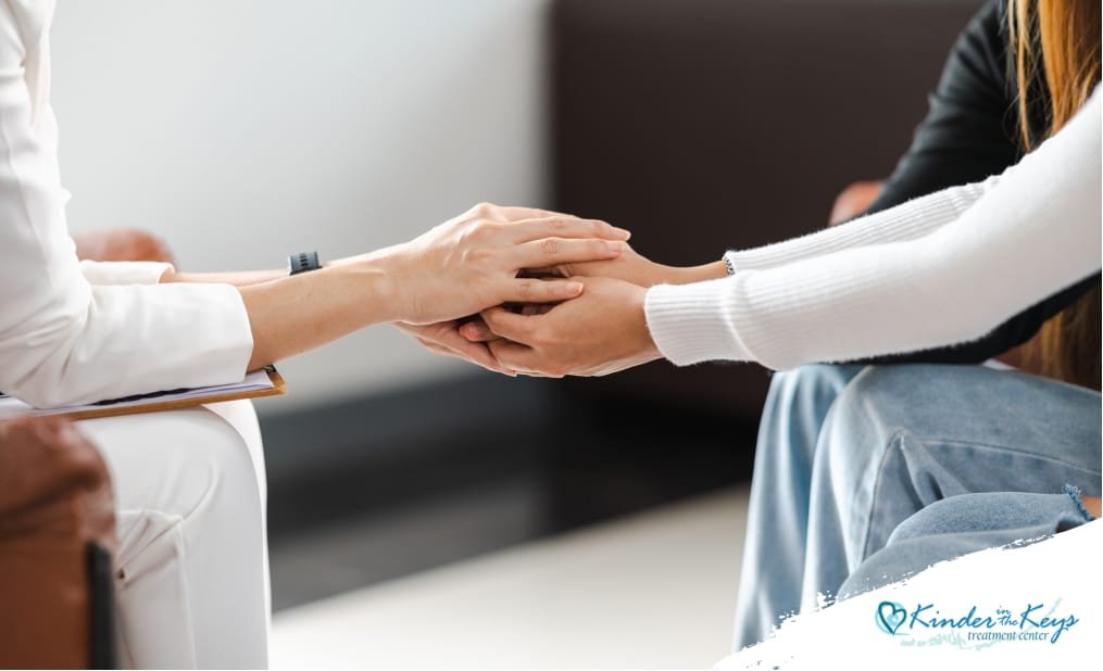 Therapist holding a woman's hands during a counseling session for depression treatment