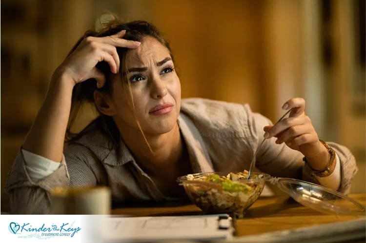 Woman anxious at mealtime, showing how anxiety affects appetite and nutrition.