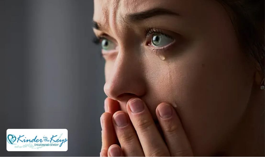 A woman recognizing warning signs of a nervous breakdown with tears coming out of her eyes