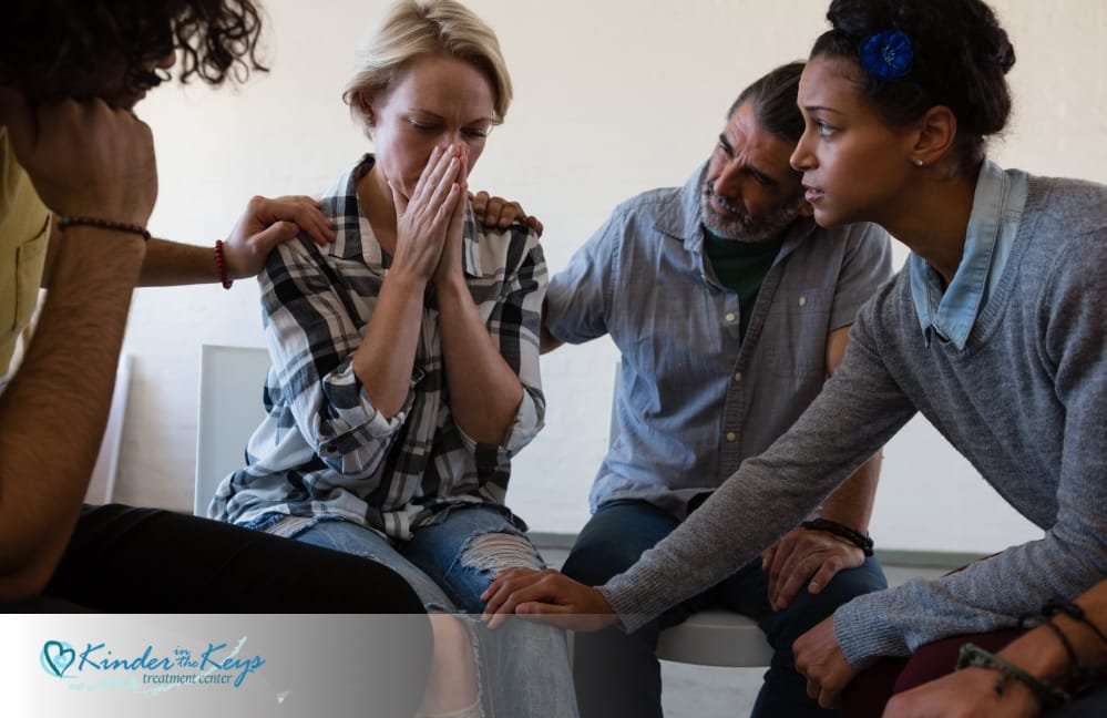 A group therapy session consoling a woman recovering from narcissistic abuse
