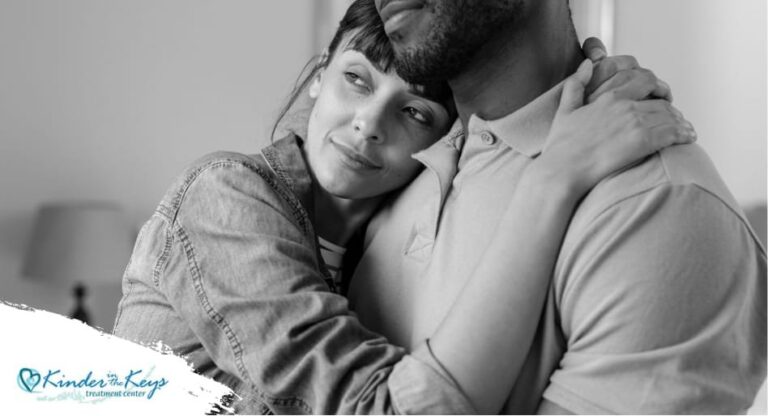 Couple hugging closely with man’s face partially out of frame