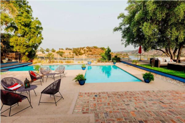outdoor view with chairs and table besides swimming pool