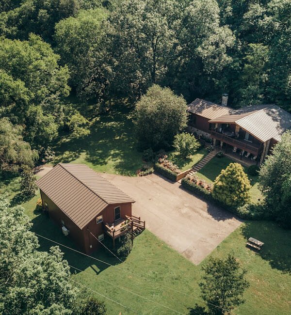 Aerial image of a barn style depression center in the woods