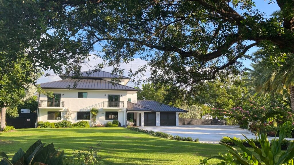 Exterior of Kinder in the Keys residential treatment center surrounded by lush greenery, offering a peaceful, trauma-informed environment for healing and recovery.