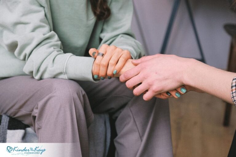 Woman receiving supportive hand symbolizing care and emotional support in residential treatment