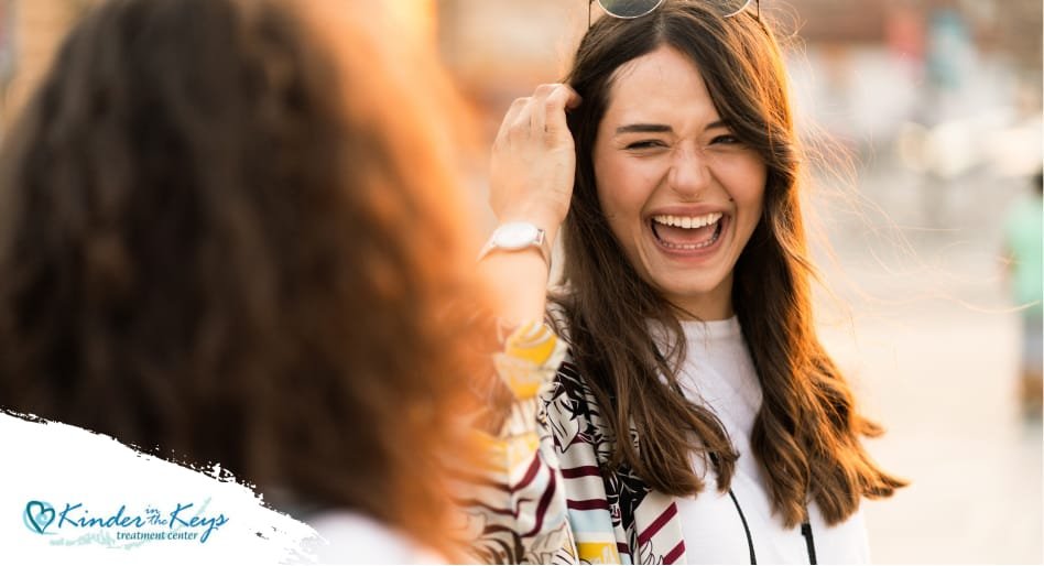 Smiling woman with friend, showing recovery from narcissistic abuse trauma.